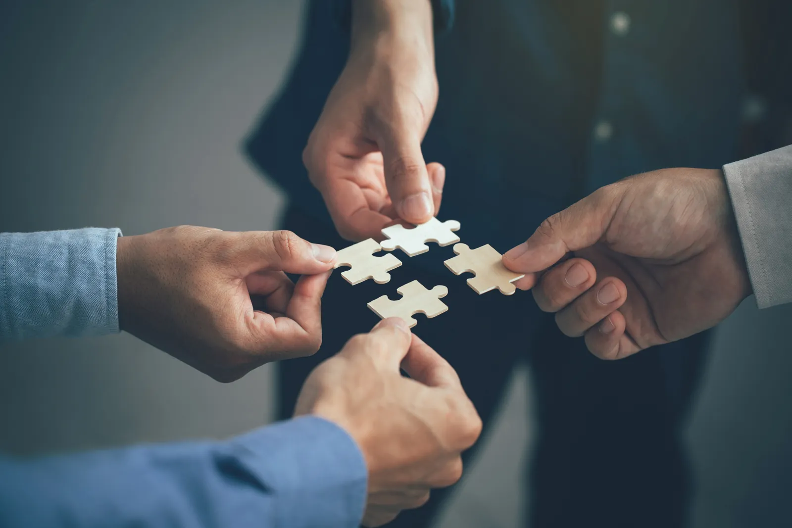 Colleagues connecting puzzle pieces